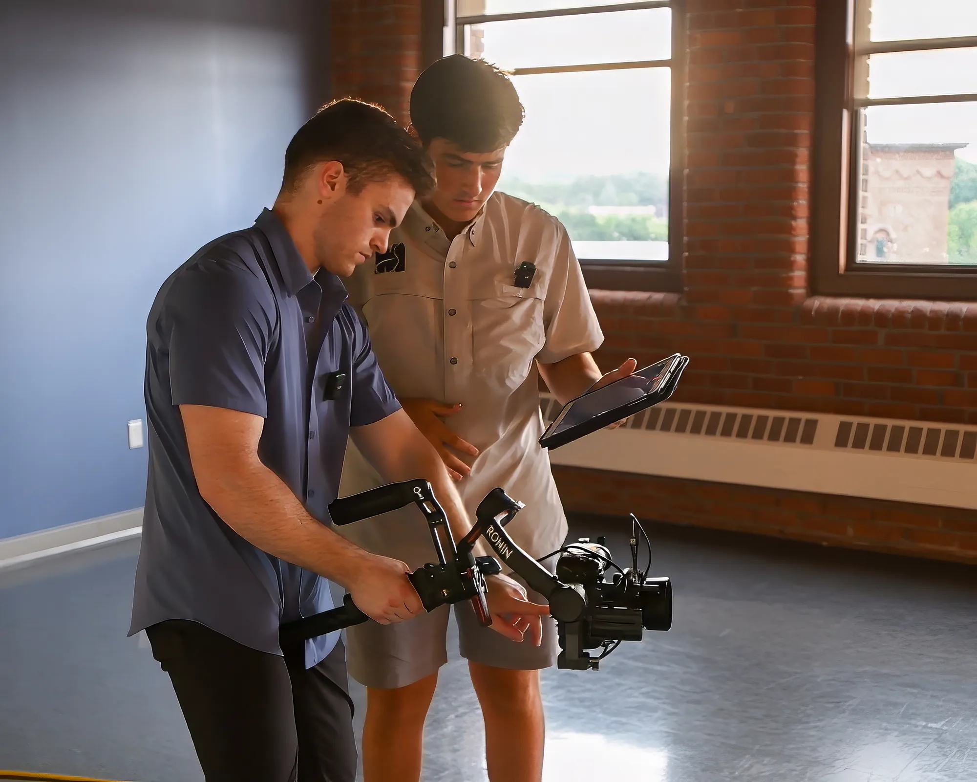 Two Soule Media crew members reviewing a tablet and camera rig during the Gus Grips shoot.