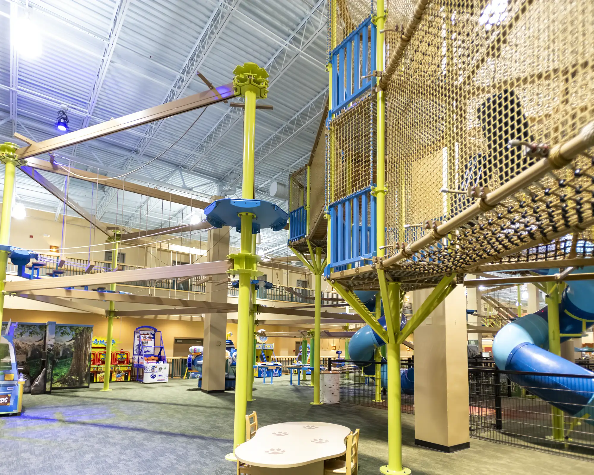 Wide view of suspended stepping discs, planks, ropes, and platforms inside the adventure park.