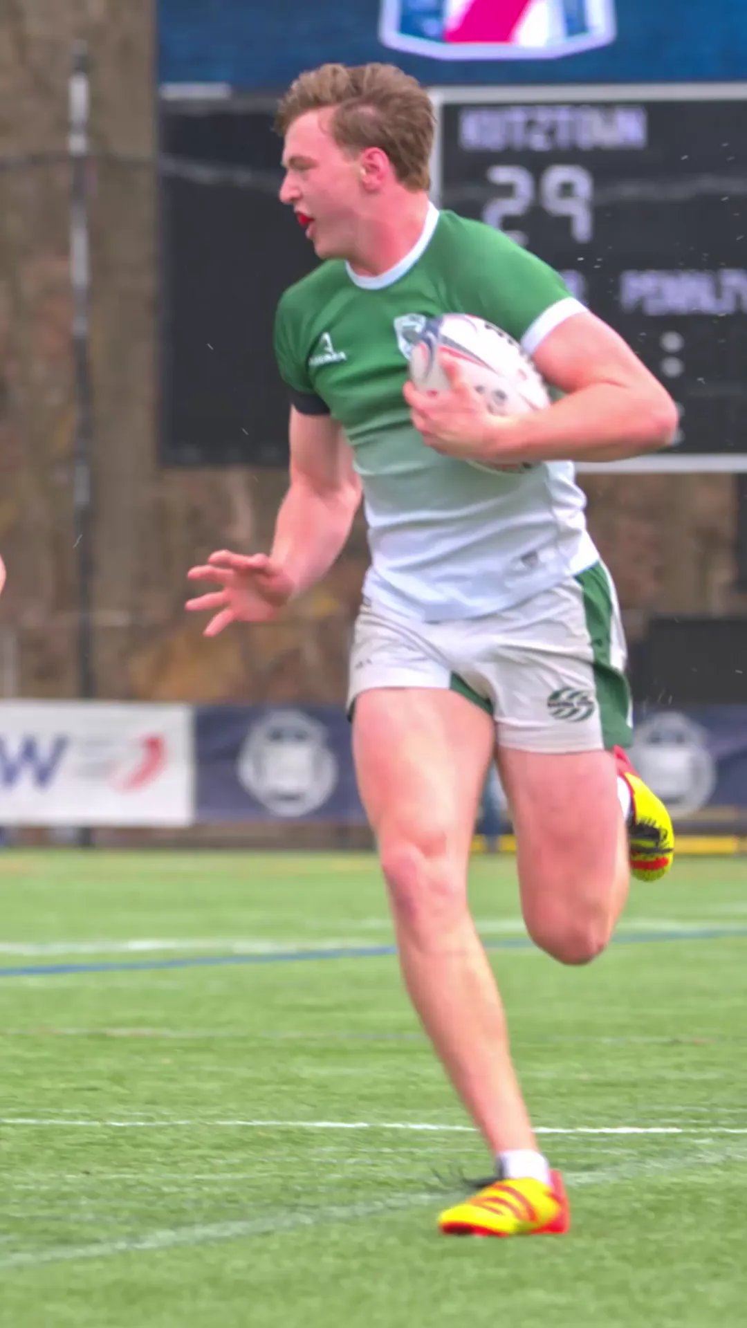 Babson Rugby player sprinting across the field with the ball.