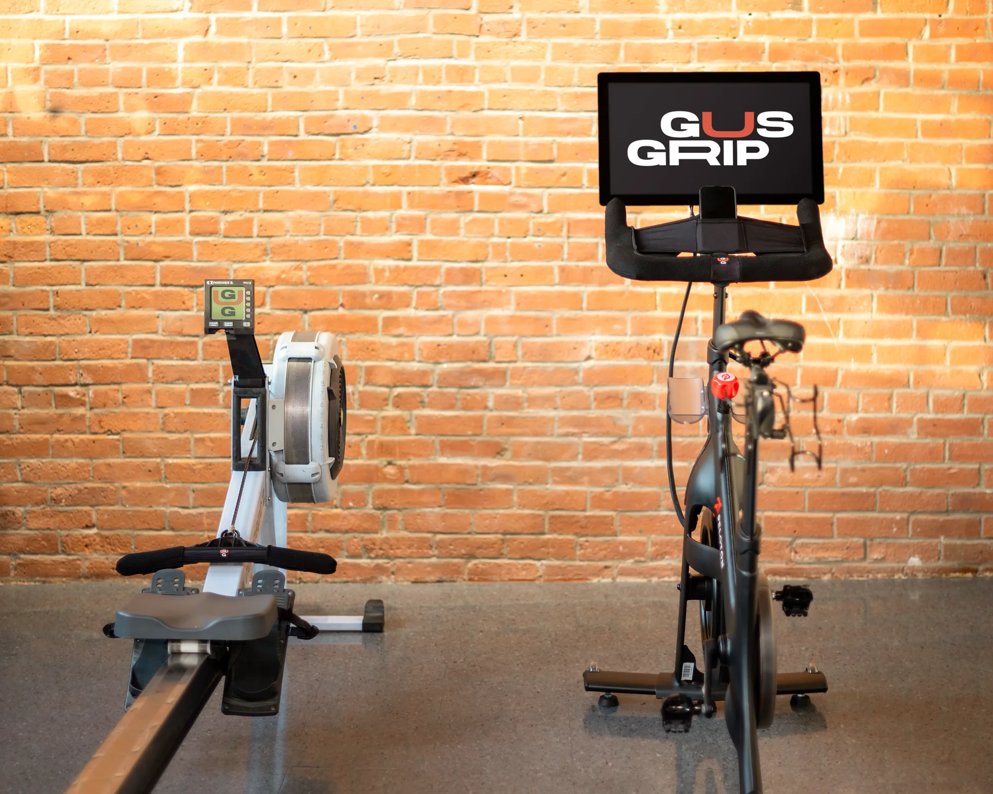 Rowing and indoor cycling machines displayed together with Gus Grips covers installed.