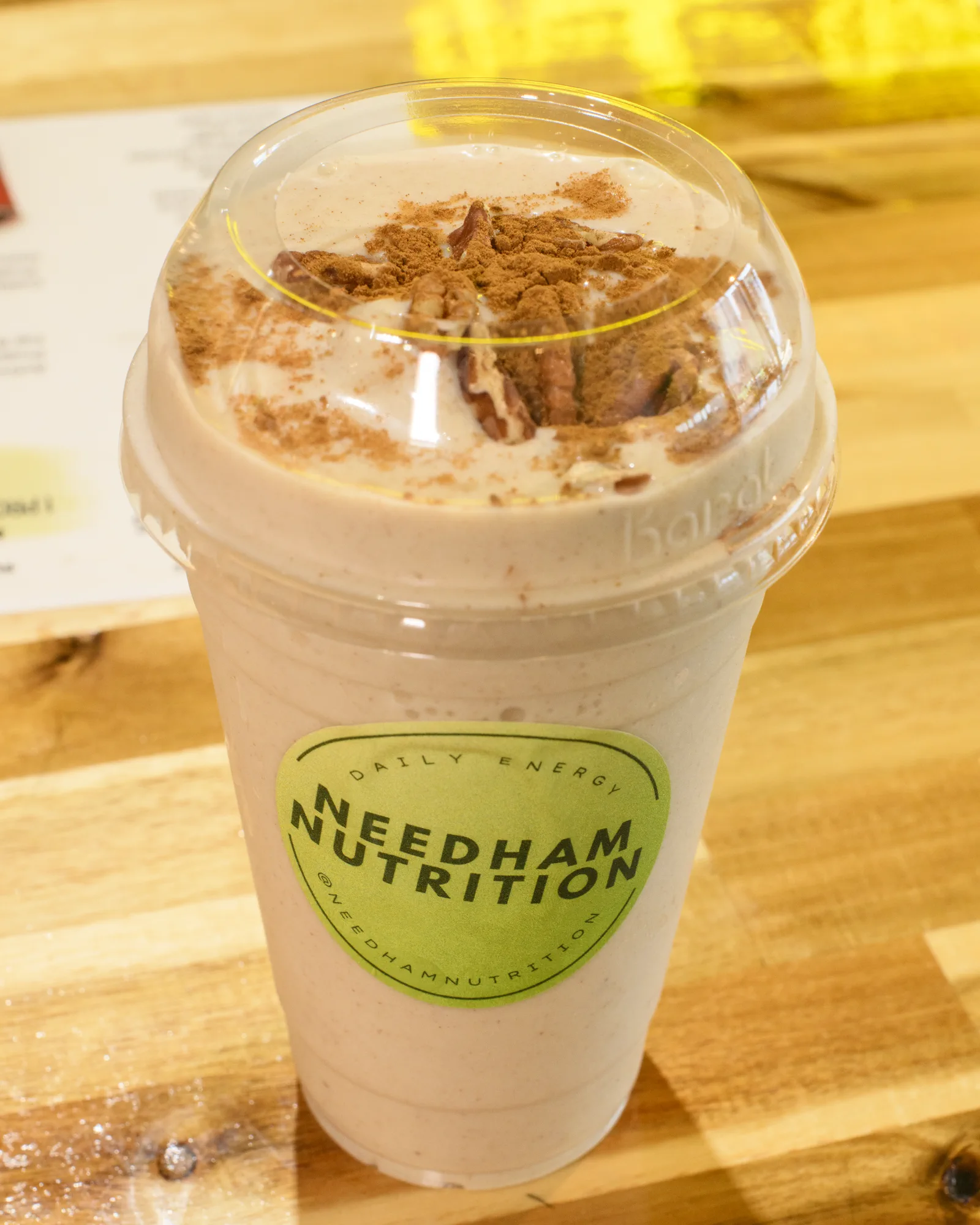 Finished Needham Nutrition shake topped with cocoa and chocolate pieces.