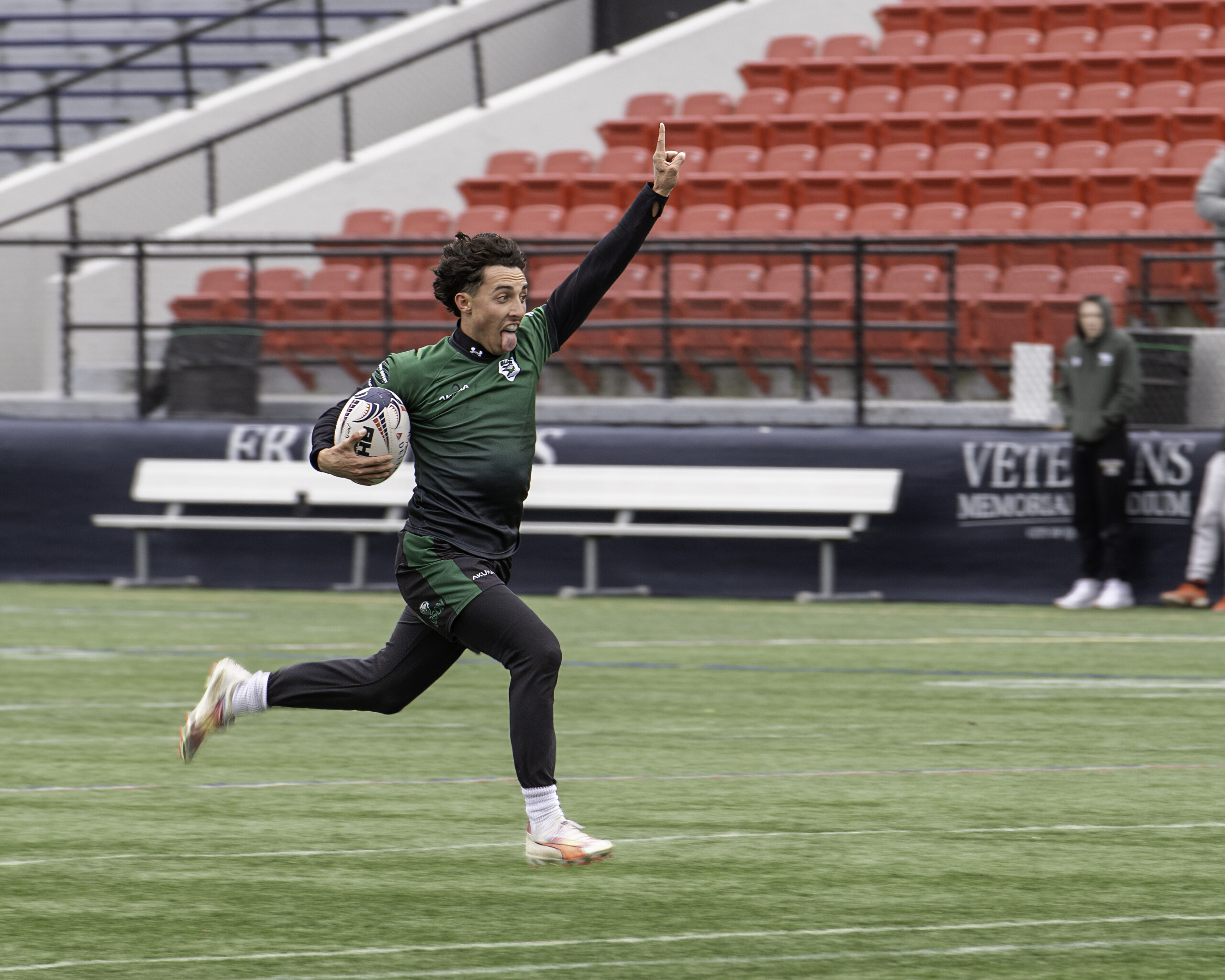 a man running on a field with a ball